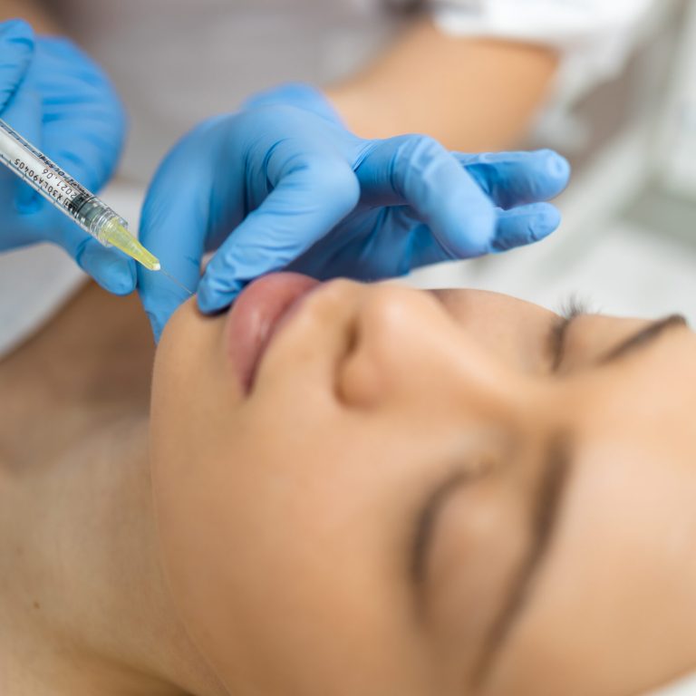 Close up of female face during the injection in the chin