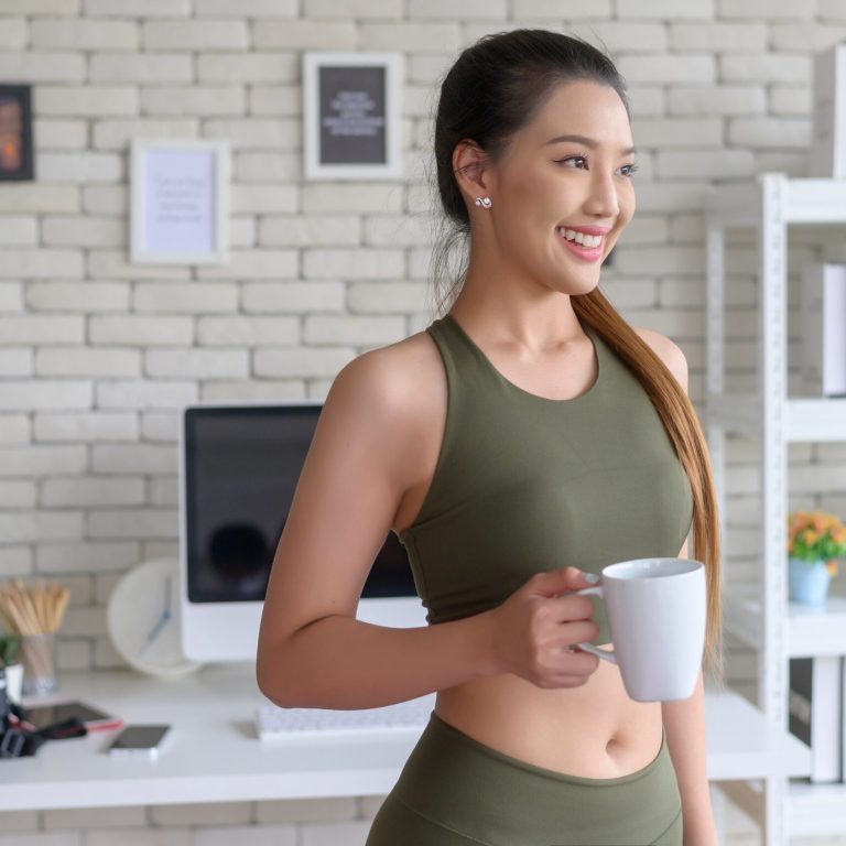 Young,Fitness,Woman,In,Sportswear,Having,A,Cup,Of,Coffee