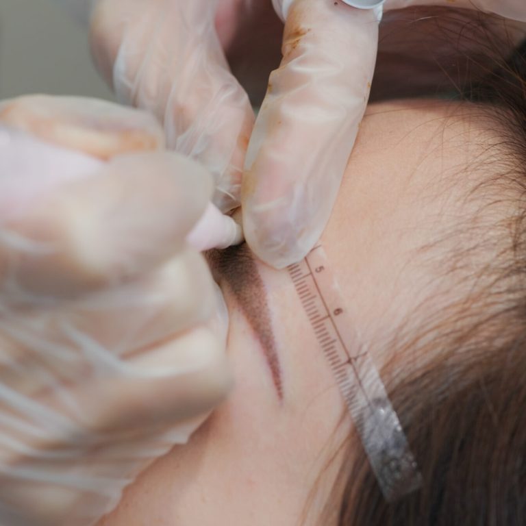 Woman undergo eyebrow microblading, permanent makeup
